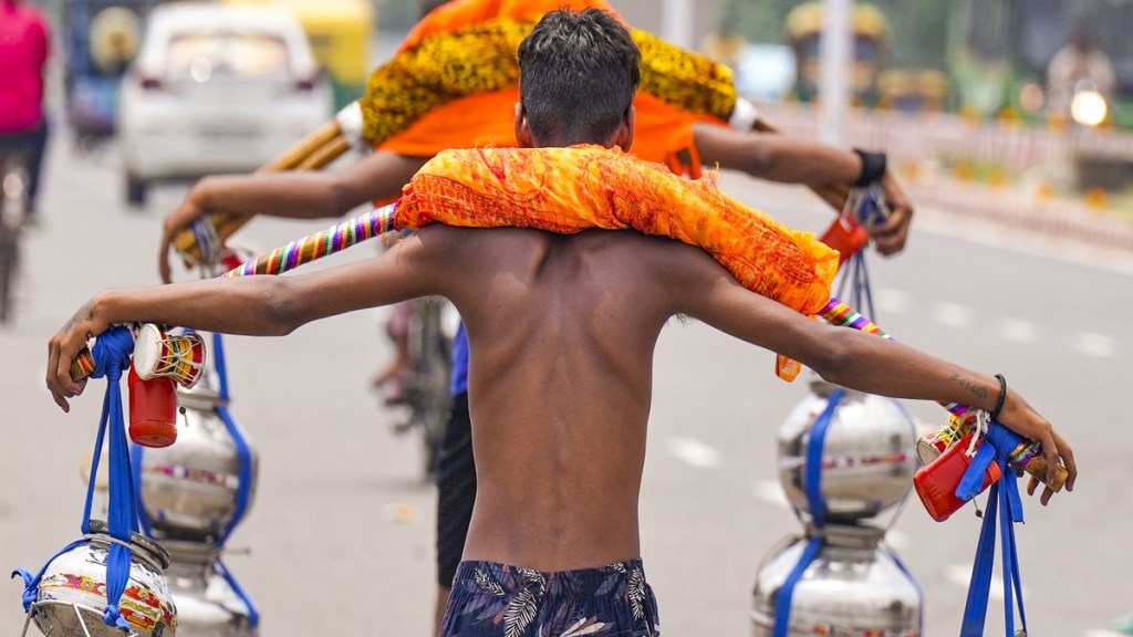 ‘Kanwariyas’ (Lord Shiva devotees) carry holy water during ‘Kanwar Yatra’ in the holy month of ‘Shravan’, in New Delhi, Thursday, Aug. 1, 2024. (PTI Photo/Manvender Vashist Lav) ‘Kanwariyas’ (Lord Shiva devotees) carry holy water during ‘Kanwar Yatra’ in the holy month of ‘Shravan’, in New Delhi, Thursday, Aug. 1, 2024. (PTI Photo/Manvender Vashist Lav)