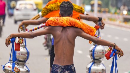 ‘Kanwariyas’ (Lord Shiva devotees) carry holy water during ‘Kanwar Yatra’ in the holy month of ‘Shravan’, in New Delhi, Thursday, Aug. 1, 2024. (PTI Photo/Manvender Vashist Lav)