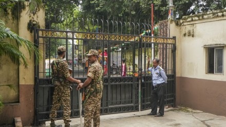 Security personnel stand guard during a raid on the premises of former principal of RG Kar Medical College Sandip Ghosh by CBI in connection with alleged financial irregularities at the institute during his tenure, in Kolkata, Sunday, Aug. 25, 2024. (PTI Photo)