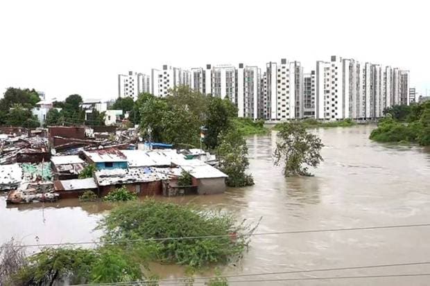 Houses partially submerged following heavy downpours, at the Akota stadium area in Vadodara. (Photo source: PTI)
