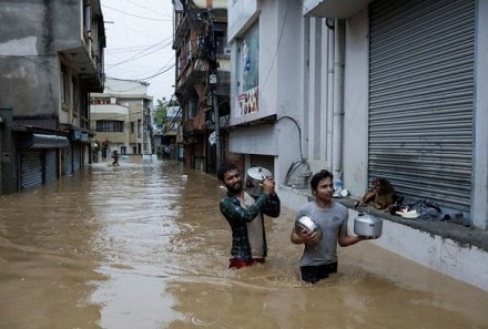 People wade through a flooded road near the bank of the overflowing Bagmati River following heavy rains, in Kathmandu, Nepal September 28, 2024. (REUTERS)