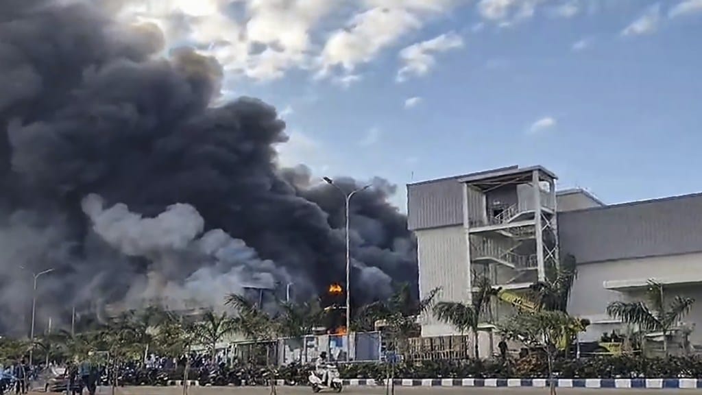 People gather near a chemical godown of the electronics component factory of Tata Electronics Pvt Ltd after a fire broke out, in Hosur, Tamil Nadu, Saturday, Sept. 28, 2024. (PTI Photo)