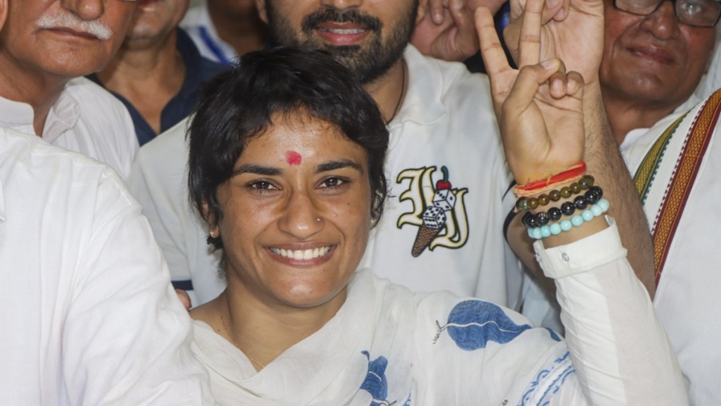 Former wrestler and Congress candidate from Julana constituency Vinesh Phogat with husband and wrestler Somvir Rathee and others during her nomination filing for the upcoming Haryana Assembly elections, in Jind district, Wednesday, Sept. 11, 2024. (PTI Photo) Former wrestler and Congress candidate from Julana constituency Vinesh Phogat with husband and wrestler Somvir Rathee and others during her nomination filing for the upcoming Haryana Assembly elections, in Jind district, Wednesday, Sept. 11, 2024. (PTI Photo)