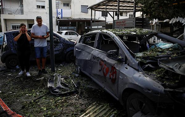 People stand near a damaged car at a site of houses damaged following a rocket attack from Lebanon, amid cross-border hostilities between Hezbollah and Israel, in Kiryat Bialik, Israel. (Photo: Reuters) People stand near a damaged car at a site of houses damaged following a rocket attack from Lebanon, amid cross-border hostilities between Hezbollah and Israel, in Kiryat Bialik, Israel. (Photo: Reuters)