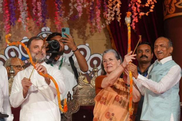 Congress leaders Sonia Gandhi and Rahul Gandhi hold bows and arrows during Vijayadashami celebration organised by Nav Shri Dharmik Leela Committee, at the Red Fort ground in Delhi. Congress leader Jai Prakash Agarwal is also seen.