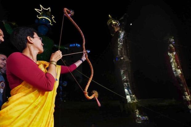 Delhi CM Atishi holds a bow & arrow during the ‘Dussehra’ (Vijayadashami) festival celebration organised by Shri Ramlila Committee Indraprastha, in Delhi.
