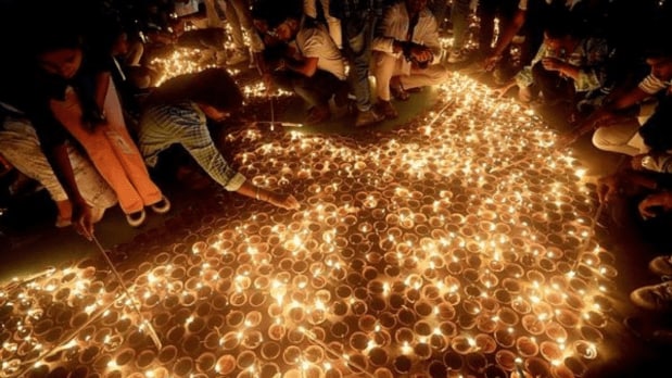 Ayodhya: Devotees light ‘diyas’ (earthen lamps) at Ram ki Paidi during ‘Deepotsav 2024’ celebrations on the eve of the Diwali festival. (PTI)