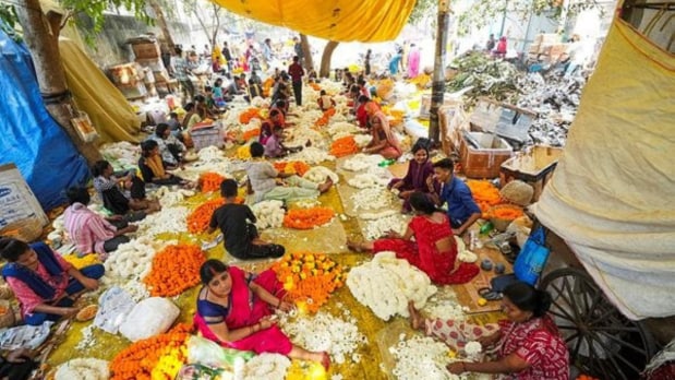 Vendors sell flowers at a flower market in Delhi ahead of the Diwali festival on Wednesday. (PTI)