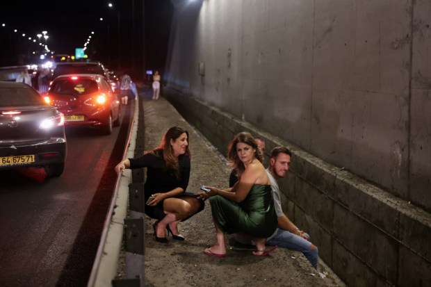 People sought shelter in central Israel as air raid sirens blared, signaling an imminent threat. Amidst the chaos, families and individuals rushed to secure locations, finding refuge in stairwells, basements, and designated safe areas. (Reuters) 