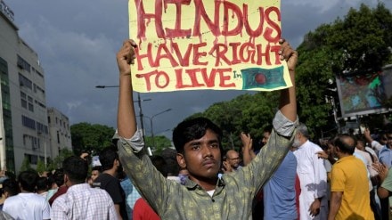 A demonstrator displays a placard during a protest , in Dhaka, Bangladesh, on August 9, 2024. Representational Photo/(Image Source: Reuters)