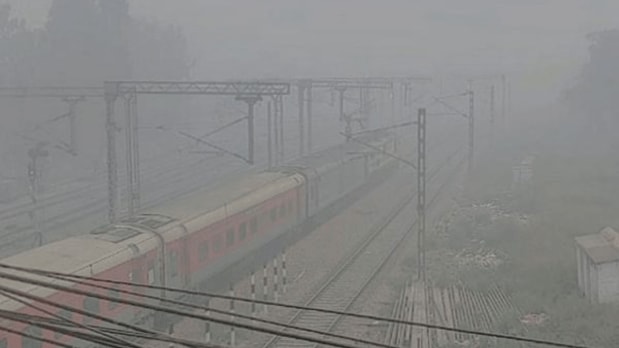 A train moves along its tracks near Patel Nagar, shrouded in dense smog as air quality remains in the 'severe' category. (PTI)