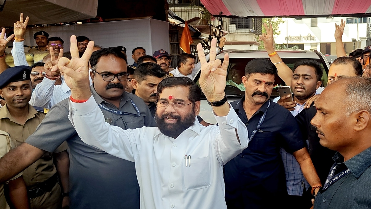 Maharashtra Chief Minister Eknath Shinde flashes victory signs along with supporters as early trends show victory for Mahayuti in Assembly polls, in Thane, Saturday, Nov. 23, 2024. (PTI Photo)