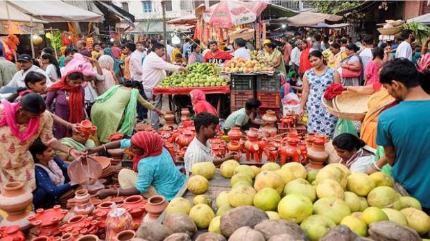 People shop ahead of the 'Chhath Puja' festival, at Sadar Bazar in Gurugram. (Image:PTI)