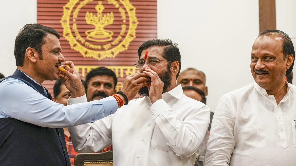 Maharashtra Chief Minister Eknath Shinde with Deputy Chief Ministers Devendra Fadnavis and Ajit Pawar celebrates the BJP-led Mahayuti alliance's lead amid the counting of votes for the Maharashtra Assembly elections, at CM's official residence 'Varsha' in Mumbai, Saturday, Nov. 23, 2024. (PTI Photo/Kunal Patil)