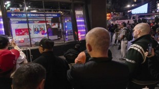 People watch an ABC News livestream showing poll results in Times Square in New York on Election Day, Tuesday, Nov. 5, 2024. AP Photo.