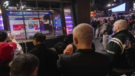 People watch an ABC News livestream showing poll results in Times Square in New York on Election Day, Tuesday, Nov. 5, 2024. AP Photo.