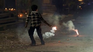 A child bursts firecrackers during celebration of the ‘Diwali’ festival, in New Delhi, Thursday, Oct. 31, 2024. (PTI Photo/Manvender Vashist Lav)