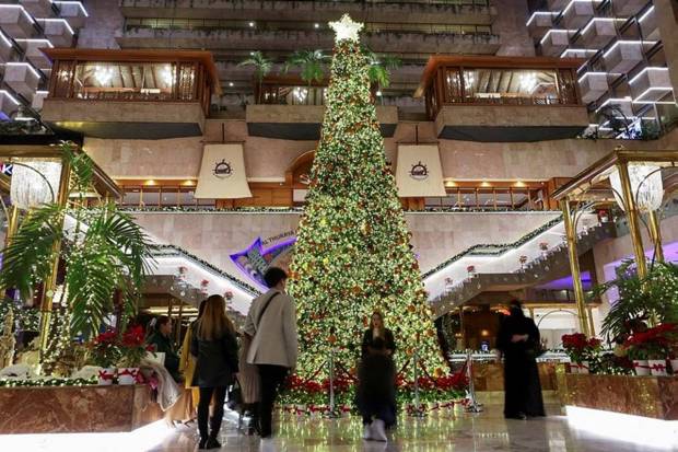 People gather around a Christmas tree in Kuwait City. (Photo source: Reuters)