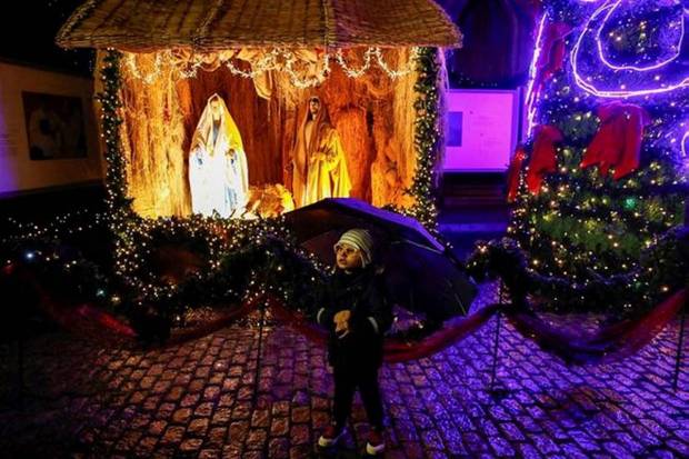 A boy stands at the courtyard of St. Antuan Catholic Church on Christmas Eve in Istanbul, Turkey. (Photo source: Reuters)