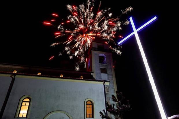 Fireworks illuminate the St. Nicholas church after the Christmas mass in the Croatian minority town, in Janjevo, Kosovo. (Photo source: Reuters)