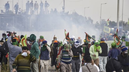 Farmers run for cover after police used teargas to disperse them during their protest at the Shambhu border, in Patiala district, Sunday, Dec. 8, 2024. (PTI Photo)