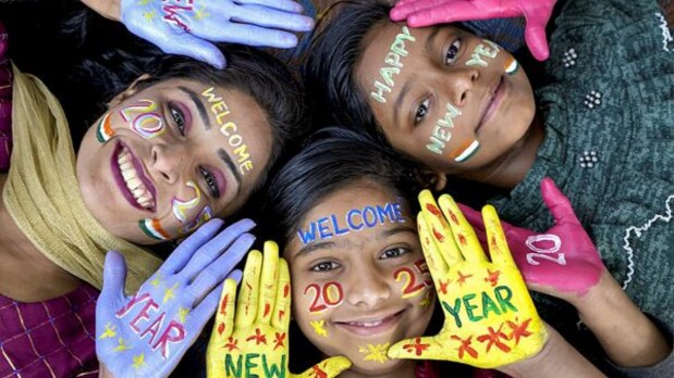 Young women pose for photos during celebrations of the New Year 2025, in Amritsar. (PTI)