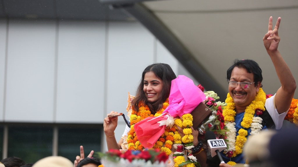 Double Olympic bronze medal-winning shooter Manu Bhaker was given a grand welcome at the Delhi airport on wednesday. Manu's coach was also seen with her. Express Photo by Gajendra Yadav. Double Olympic bronze medal-winning shooter Manu Bhaker was given a grand welcome at the Delhi airport on wednesday. Manu's coach was also seen with her. Express Photo by Gajendra Yadav.