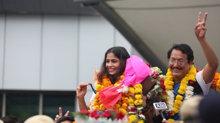 Double Olympic bronze medal-winning shooter Manu Bhaker was given a grand welcome at the Delhi airport on wednesday. Manu's coach was also seen with her. Express Photo by Gajendra Yadav. Double Olympic bronze medal-winning shooter Manu Bhaker was given a grand welcome at the Delhi airport on wednesday. Manu's coach was also seen with her. Express Photo by Gajendra Yadav.