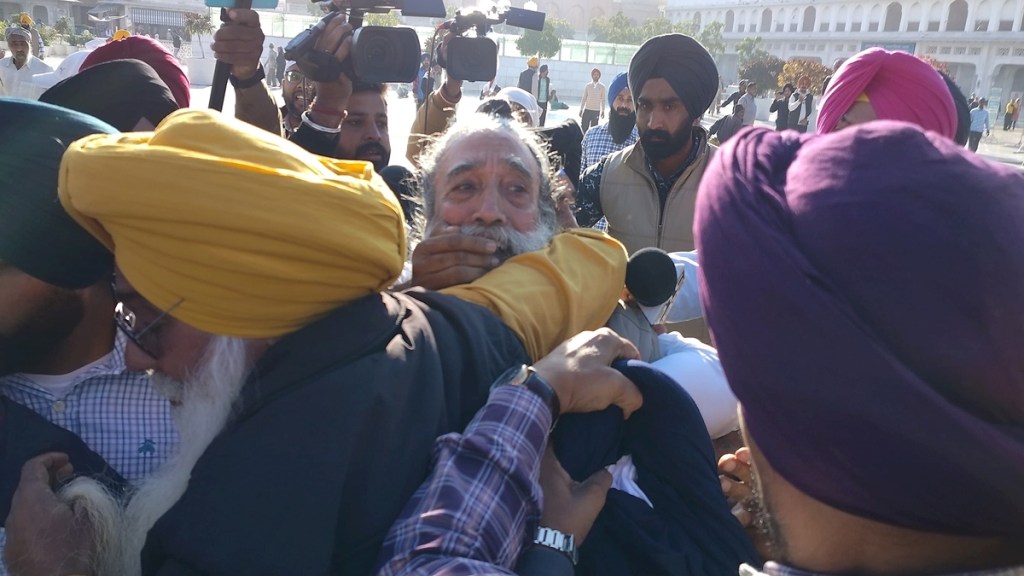 People catch a man, center, who allegedly opened fire at Shiromani Akali Dal leader Sukhbir Singh Badal while the latter was performing the duty of 'sewadar' outside the Golden Temple, in Amritsar, Wednesday, Dec. 4, 2024. (PTI Photo) People catch a man, center, who allegedly opened fire at Shiromani Akali Dal leader Sukhbir Singh Badal while the latter was performing the duty of 'sewadar' outside the Golden Temple, in Amritsar, Wednesday, Dec. 4, 2024. (PTI Photo)