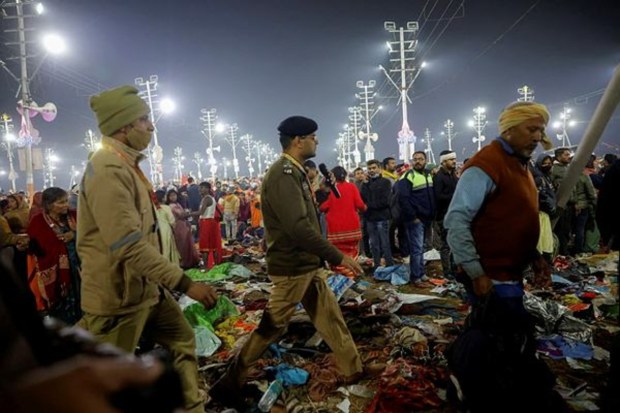 Policemen walk away after a deadly stampede occurred before the second 