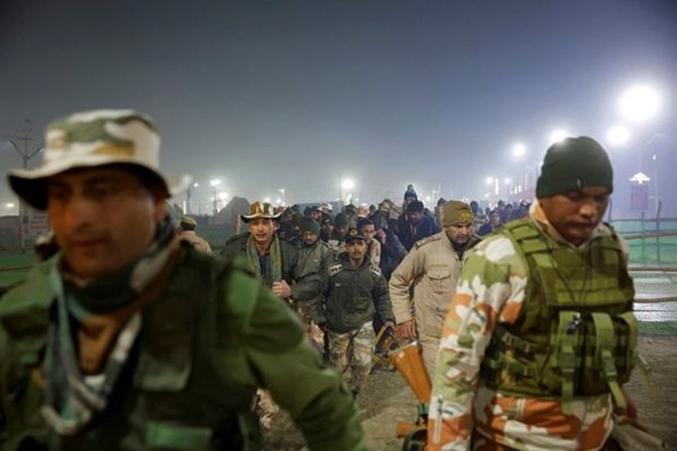 Security personnel walk towards the stampede site following a deadly stampede before the second 