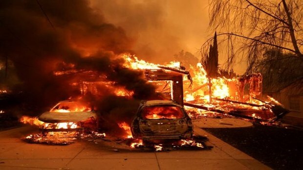 As strong winds drive the destructive wildfires in the Los Angeles area, vehicles and a home burn, forcing evacuations at the Eaton Fire in Altadena, California, on January 8, 2025. (Image Source: Reuters)