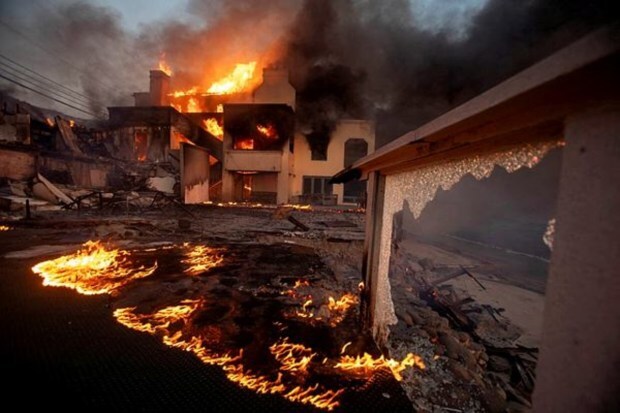 Flames and smoke billow from buildings as the Palisades fire rages during a windstorm on the west side of Los Angeles, California, on January 8, 2025. (Image Source: Reuters)