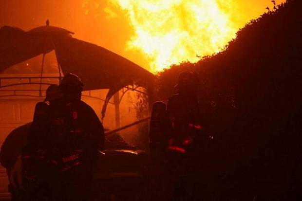 Firefighters work to extinguish flames at a McDonald's restaurant as the Eaton Fire burns in Pasadena. (Photo source: Reuters)