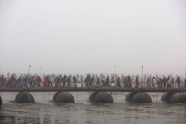 Devotees cross pontoon bridges on the day they take a holy dip. (Photo source: Reuters)
