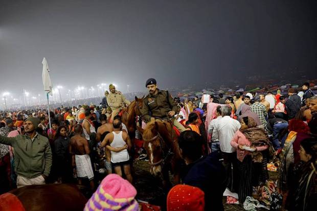 . Police officers patrol on horses as devotees gather at the river bank. (Photo source: Reuters)