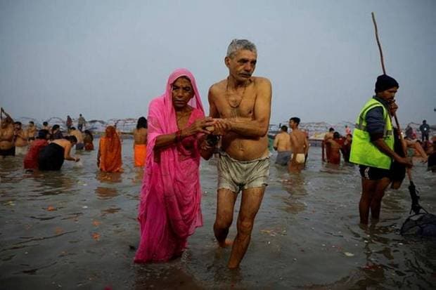 People leave the water after taking a holy dip at Sangam. (Photo source: Reuters).