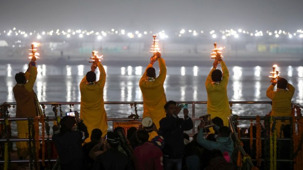 Prayagraj: Priests perform Ganga Aarti on a cold winter evening at Dashashwamedh Ghat. (PTI Photo)