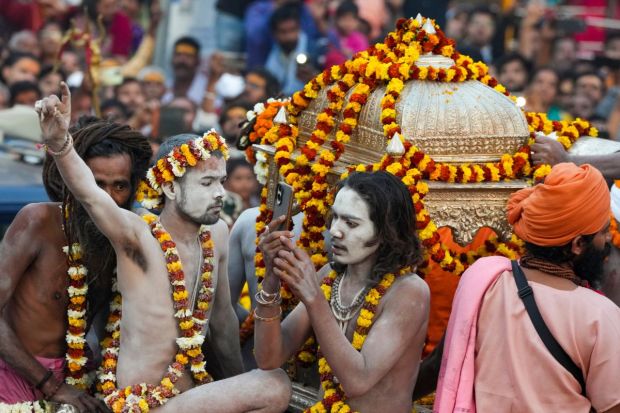  A 'Naga Sadhus' takes part in a procession towards the Kashi Vishwanath temple to offer prayers on the occasion of Maha Shivratri. (Image: PTI)