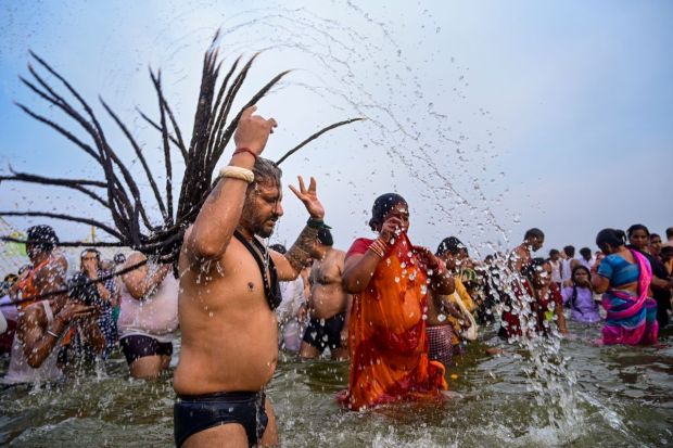 Devotees take a holy dip at the Triveni Sanam at the auspicious Maha Shivratri which saw more than 80 lakh attendees in one day. (Image: PTI)