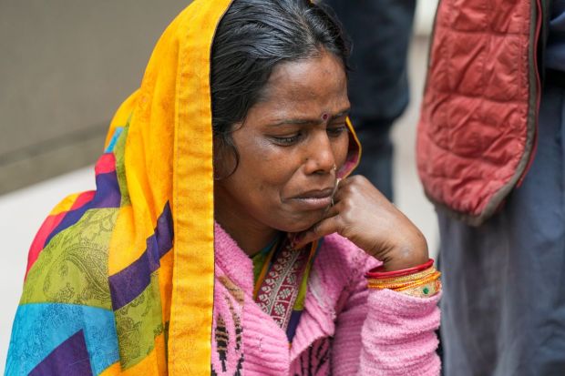 A family member of Poonam Devi, a woman from Bihar's Chapra who died in the New Delhi railway station stampede, mourns outside the Lok Nayak Jai Prakash (LNJP) Hospital, in New Delhi.(Image: PTI)
