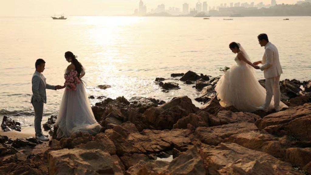 Couples take part in their pre-wedding photoshoots by the sea in Qingdao, Shandong province, China April 21, 2024. (Image Source: Reuters)
