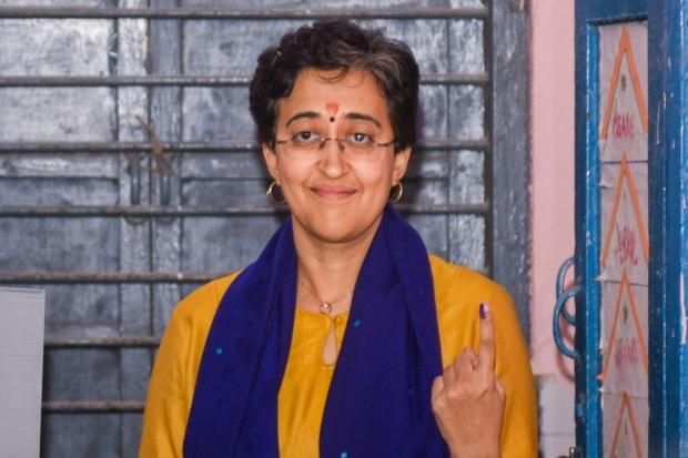Delhi Chief Minister and AAP candidate Atishi shows her inked finger after casting her vote at a polling booth during the Delhi Assembly elections, at Kalkaji.