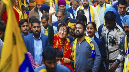 Delhi Chief Minister Atishi greets supporters during her election campaign for the upcoming Delhi Assembly polls, in New Delhi. (@AtishiAAP on X)