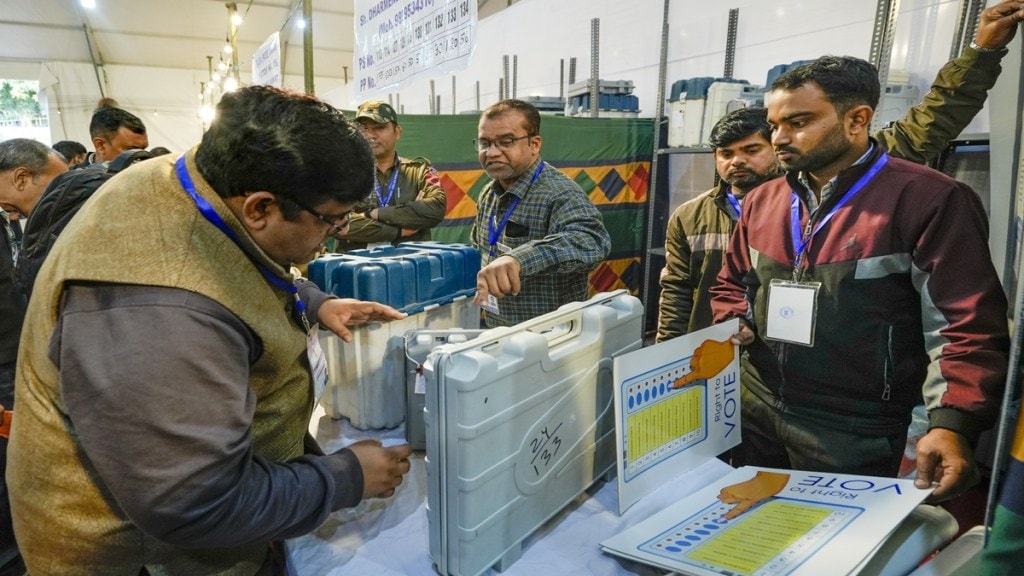 Polling officials collect Electronic Voting Machine (EVM) and other election material at a distribution center on the eve of the Delhi Assembly elections, at Gole Market in New Delhi, Tuesday, Feb. 4, 2025. (PTI Photo)