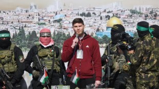 Russian-Israeli Sasha (Alexander) Troufanov, a hostage held in Gaza since the deadly October 7, 2023 attack, speaks as he is released by Palestinian Hamas and Islamic Jihad militants as part of a ceasefire and a hostages-prisoners swap deal between Hamas and Israel in Khan Younis, in the southern Gaza Strip, February 15, 2025. REUTERS/Ramadan Abed