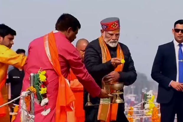 PM Modi with priests as they facilitate the rituals at the Ghat offering prayers on this auspicious day for many. (Image source: ANI)