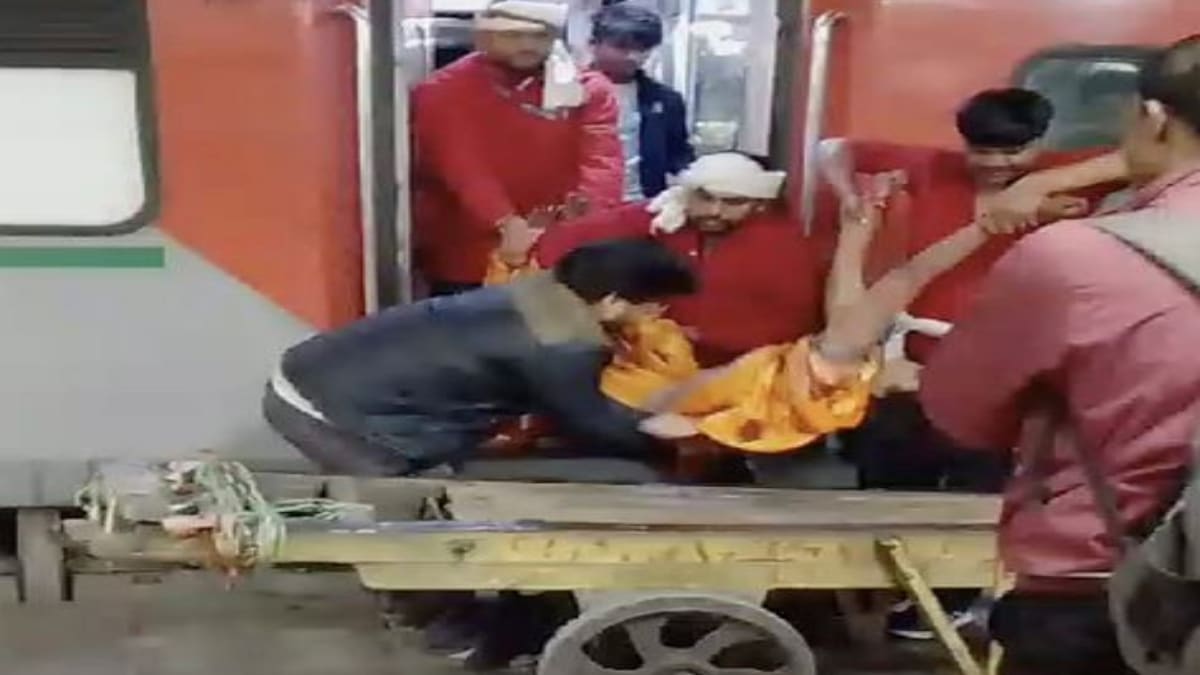SCREENSHOT FROM A VIDEO* New Delhi: A woman, who fell unconscious, being taken on a trolly from a train, at the New Delhi railway station, Saturday, Feb. 15, 2025. A stampede-like situation occurred due to heavy rush of passengers to catch a train for Mahakumbh. (PTI Photo)