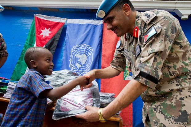 Jordanian blue helmets in a stabilisation mission distribute school supplies in Haiti to children in need. (Image: UN Photo)