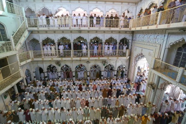 People gather in large numbers in Prayagraj as families exchange gifts, wear new clothes, and gather for lavish Eid feasts after a month of fasting. (Image: PTI)